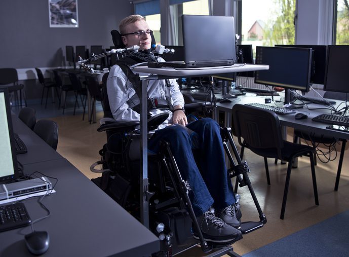 A disabled man uses assistive technology