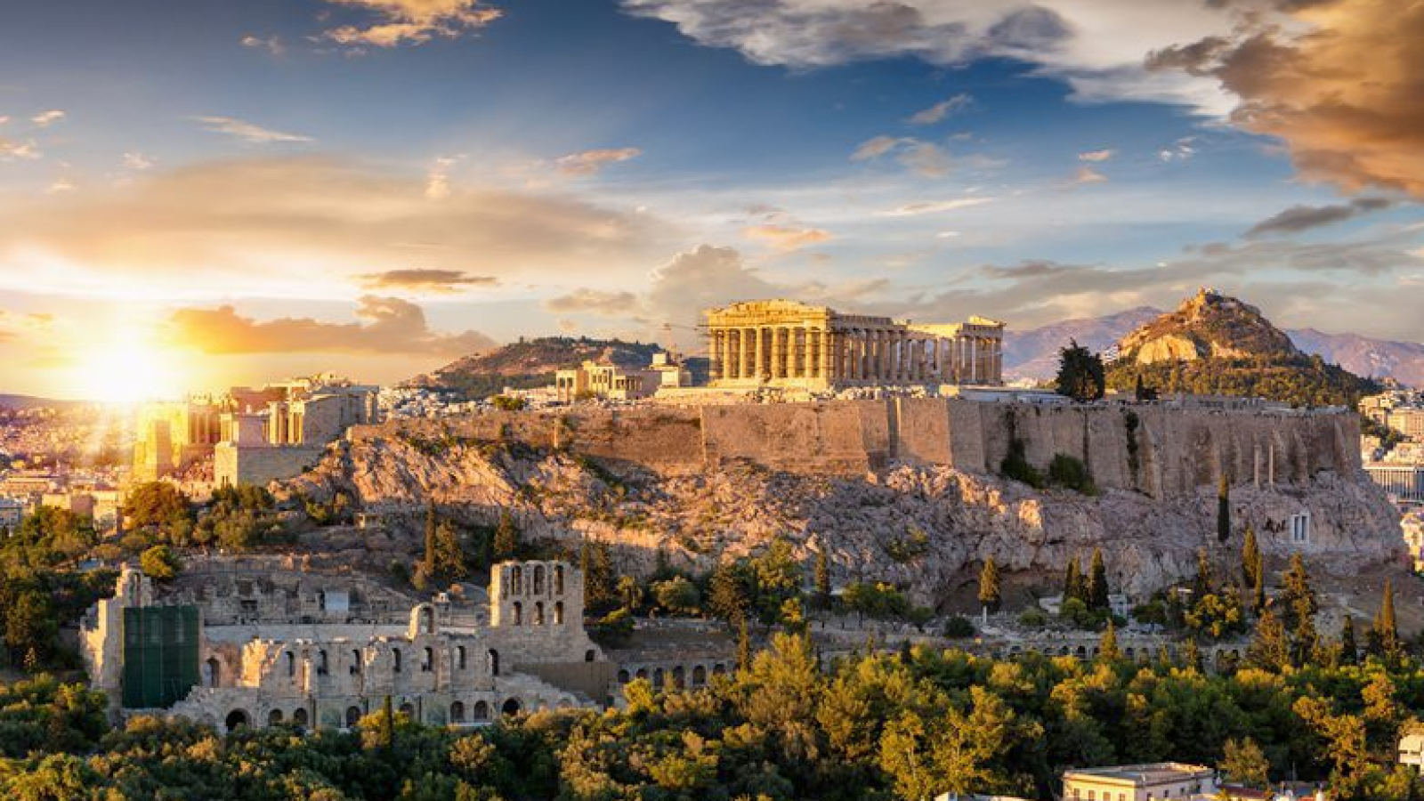 The Acropolis of Athens, Greece, with the Parthenon Temple on top of the hill during a summer sunset