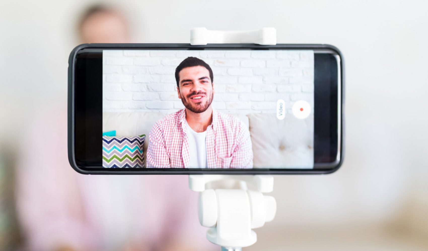 Mobile screen showing the man recording his vlog at home