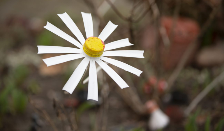 Garden decoration made from recycled plastic. Chamomile from a plastic bottle.
