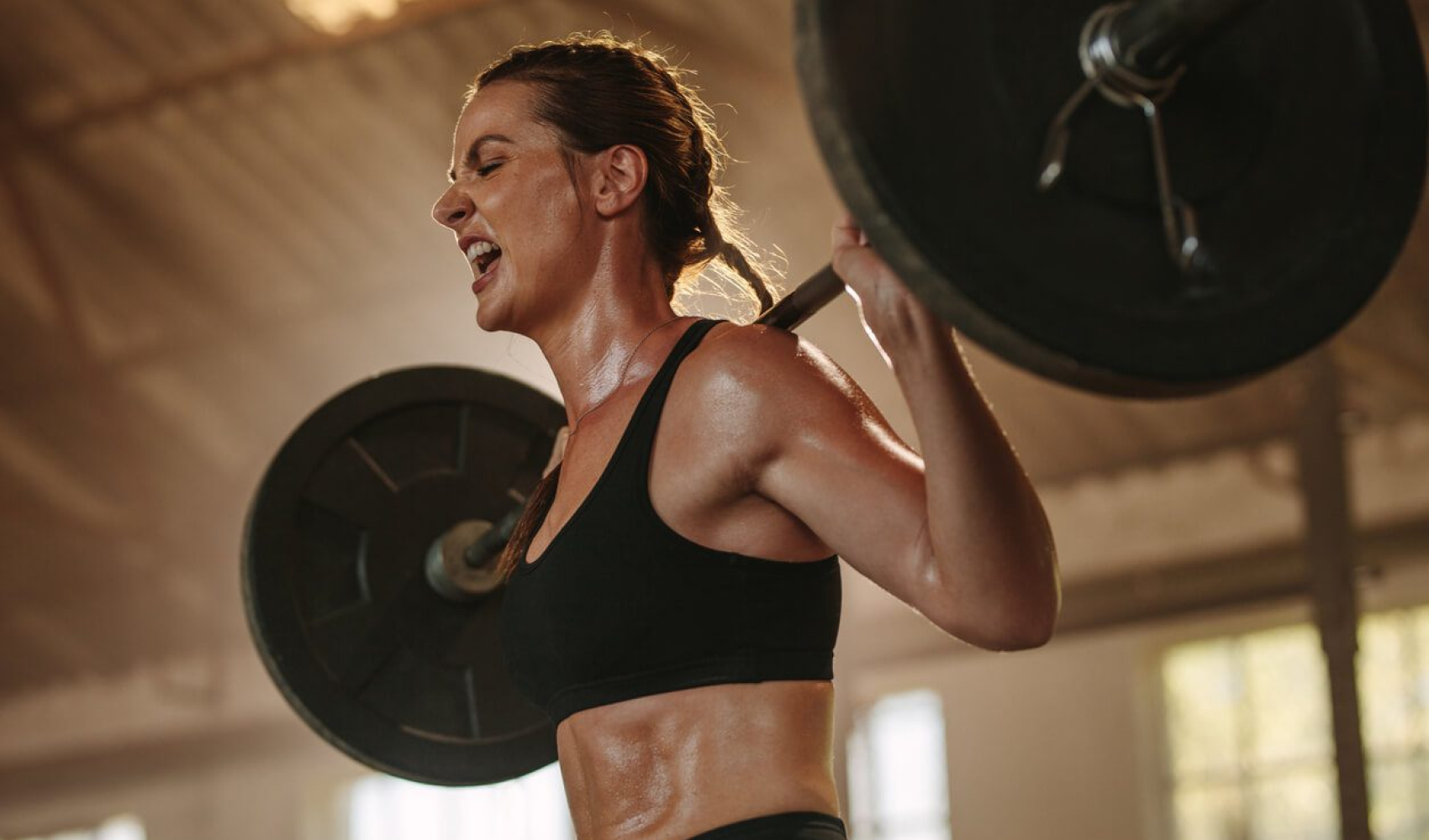 Strong woman exercising with heavy weights